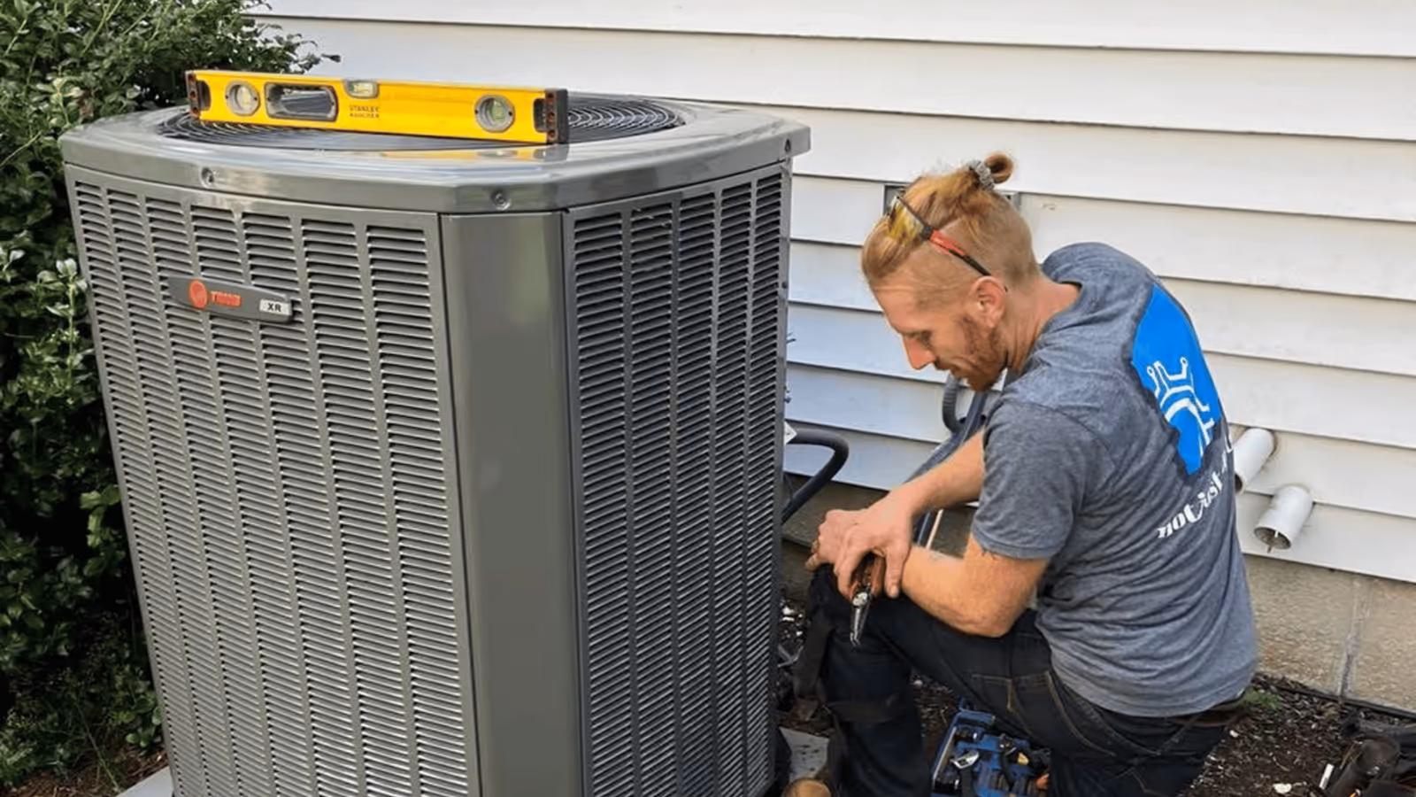Yorktowne technician maintaining an outdoor AC unit