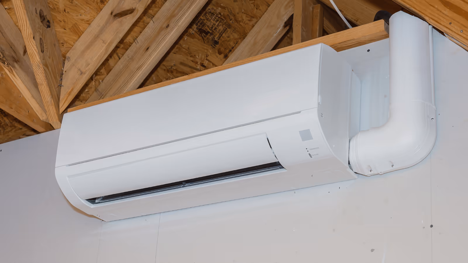 Ductless mini-split unit mounted high on a wall