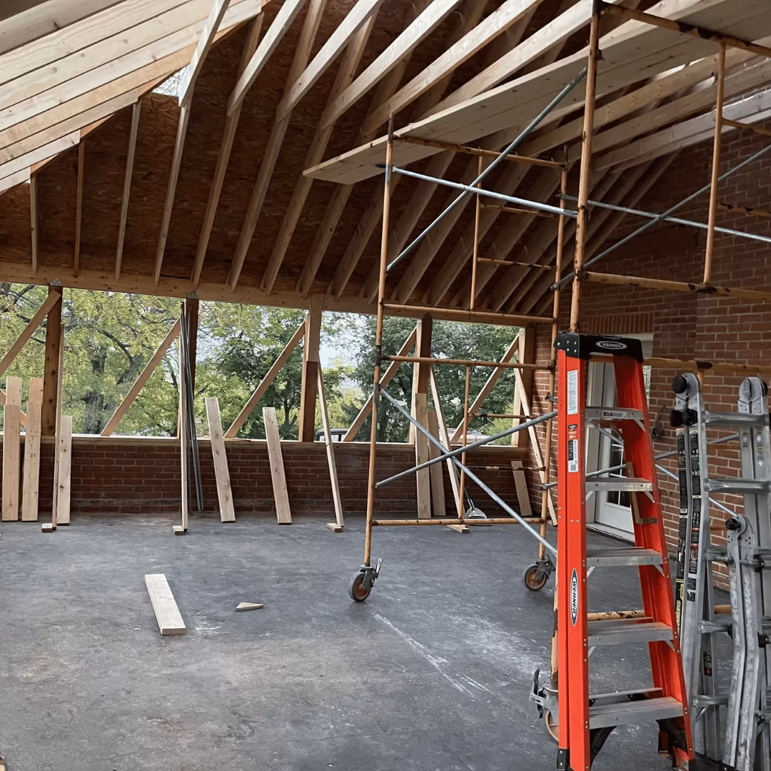 Roof framing and scaffolding inside a room under repair