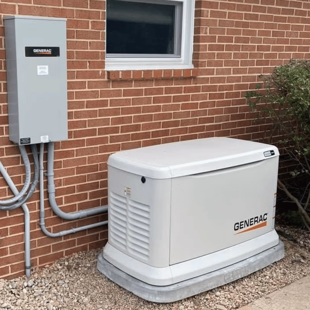 Generac standby generator and transfer switch beside a brick home