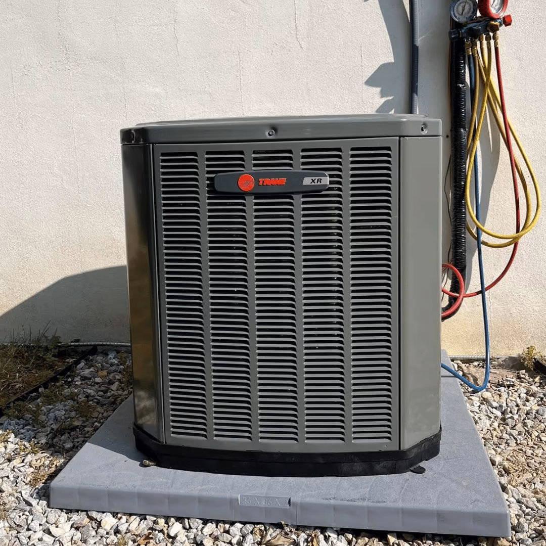 Trane outdoor air conditioner with service gauges beside it