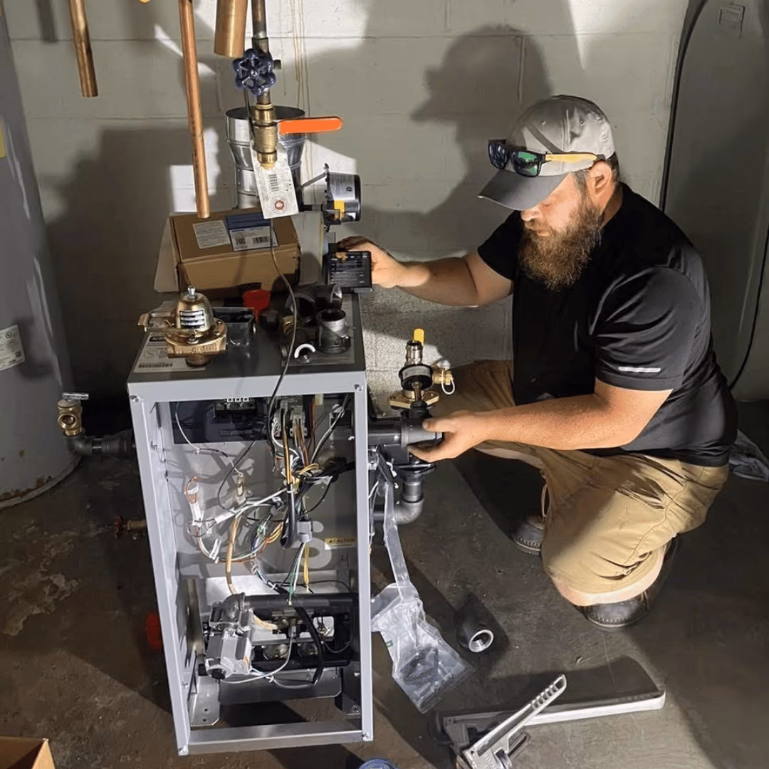 Yorktowne technician servicing a furnace in a utility room