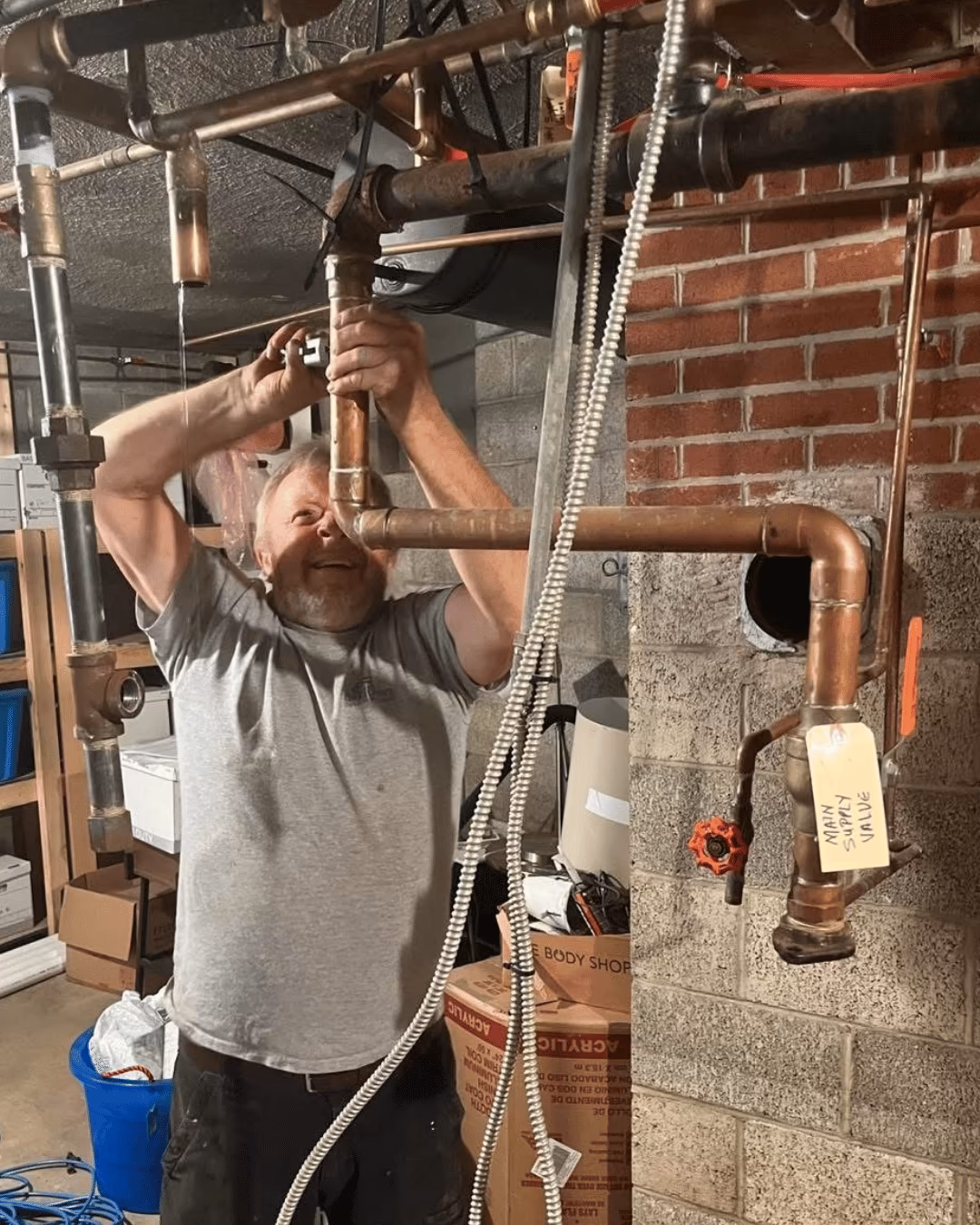 Yorktowne technician working on copper plumbing in a basement