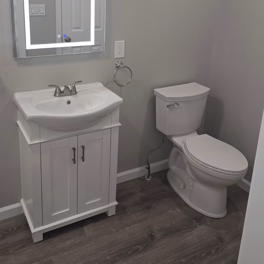 White bathroom vanity, sink, and toilet