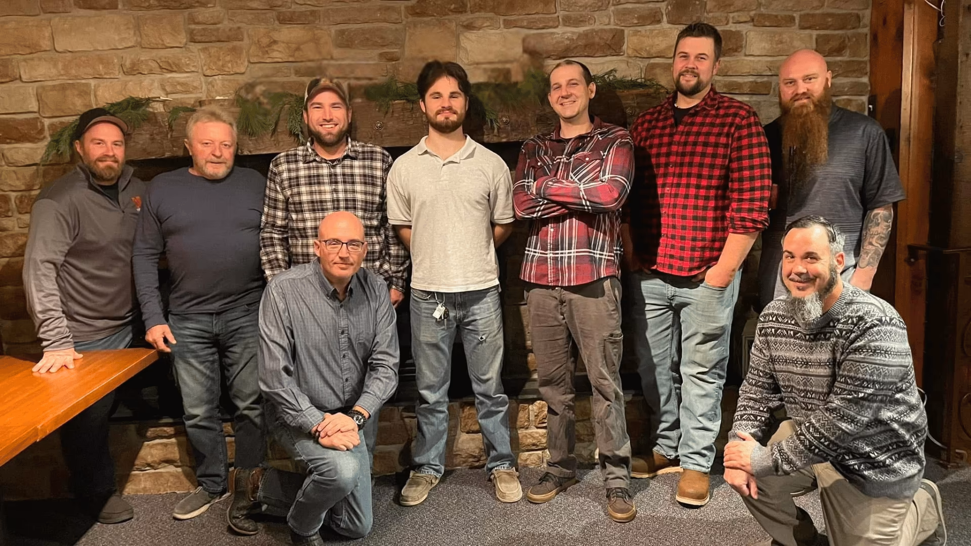 The Yorktowne Services team gathered in front of a stone fireplace