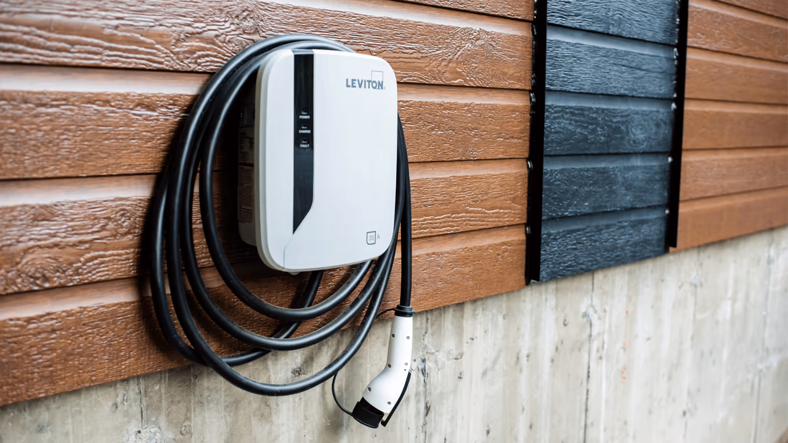 Wall-mounted Level 2 EV charger on a home's exterior