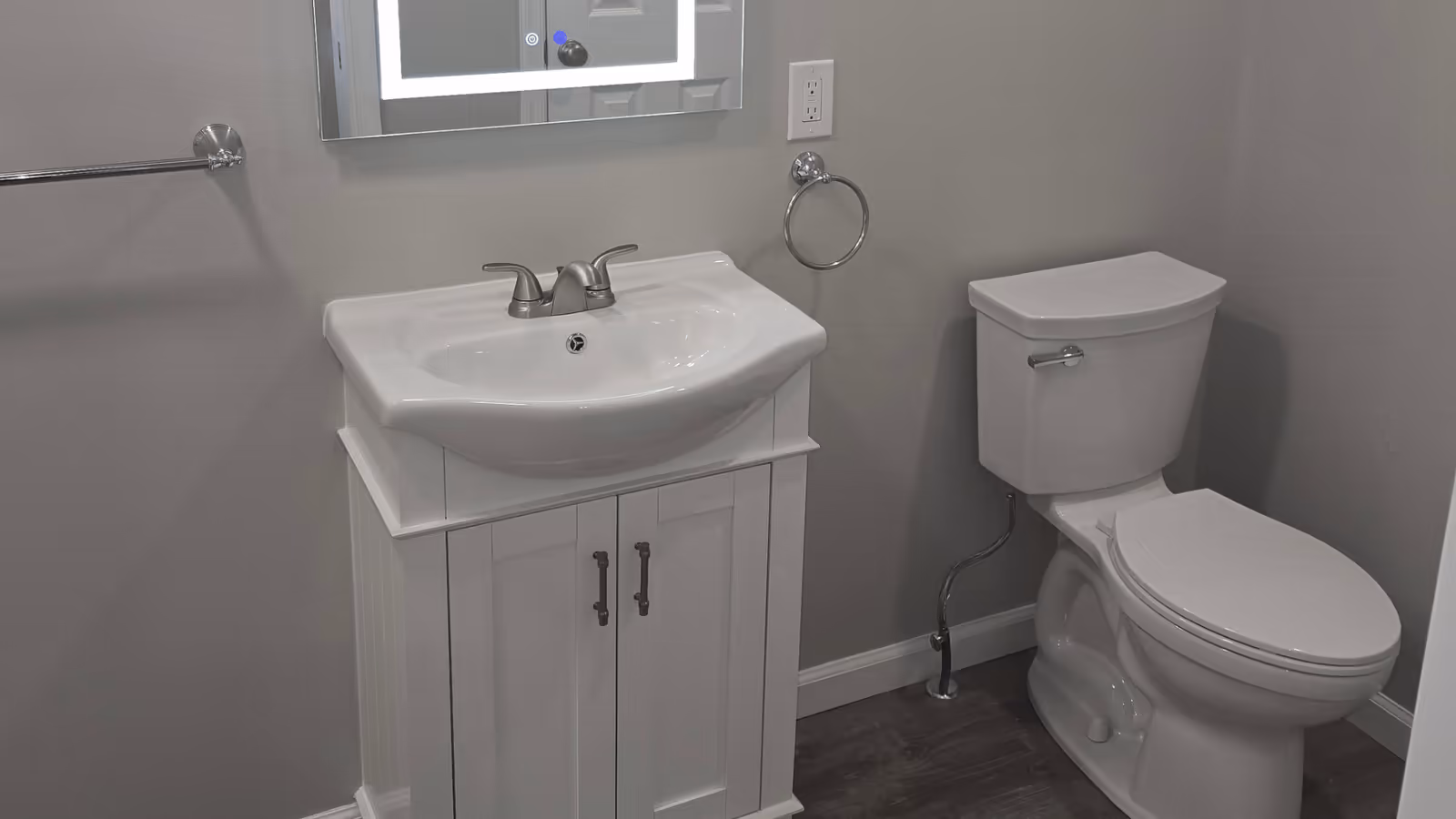 Newly installed bathroom vanity, sink, and toilet