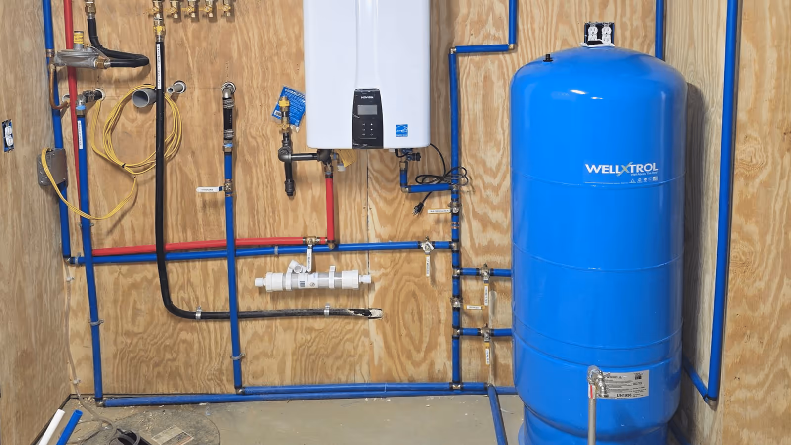 Tankless water heater and expansion tank in a utility room